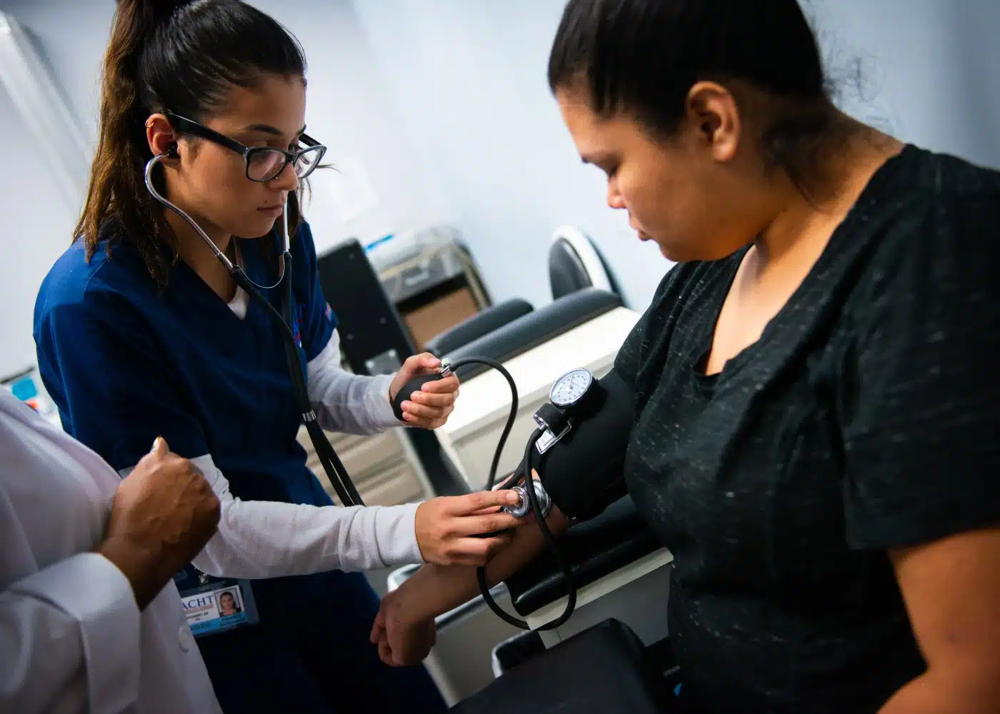 ACHT student practicing clinical medical assistant skills in a training lab