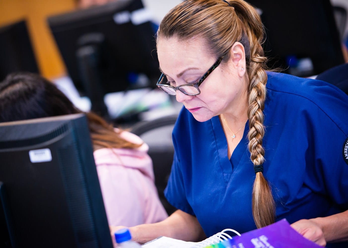 Medical billing and coding student practicing with healthcare software